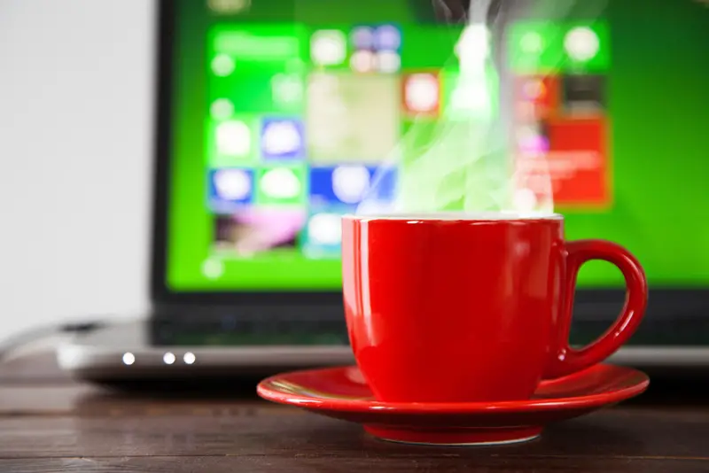 coffee cup and laptop screen